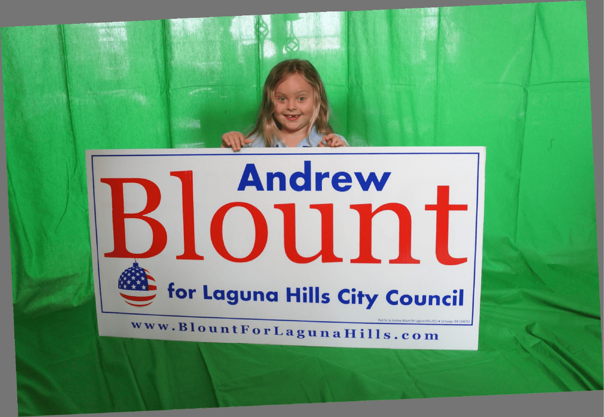 Faith Blount holding an Andrew Blount for Laguna Hills City Council sign